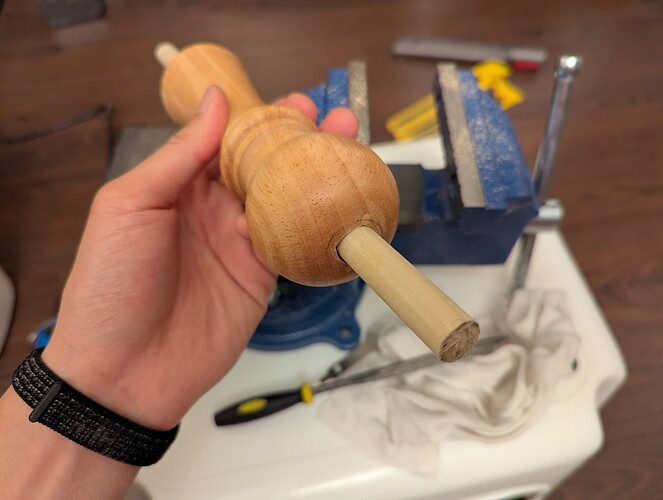 The dowel fits reasonably straight through the hole.