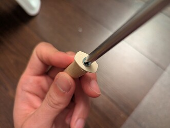 Adding a little piece to keep the dowel from sliding out the back of the light.