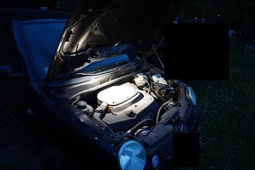 Light stuck to car hood and used to illuminate the engine